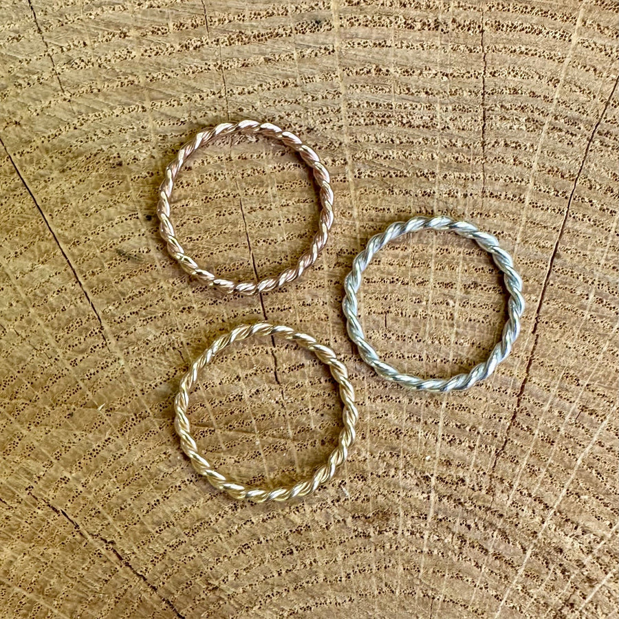 Three stacking rings on a textured wood surface