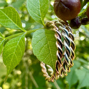 Three stacking rings hanging among green leaves